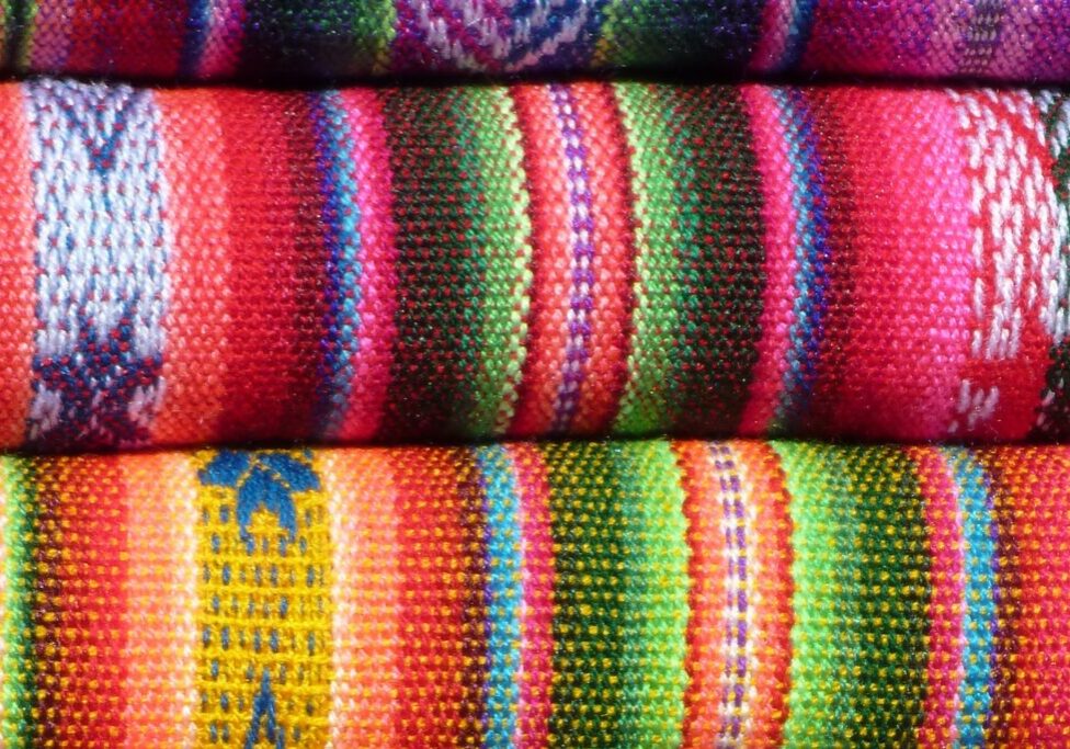 Brightly coloured bales of woven cloth