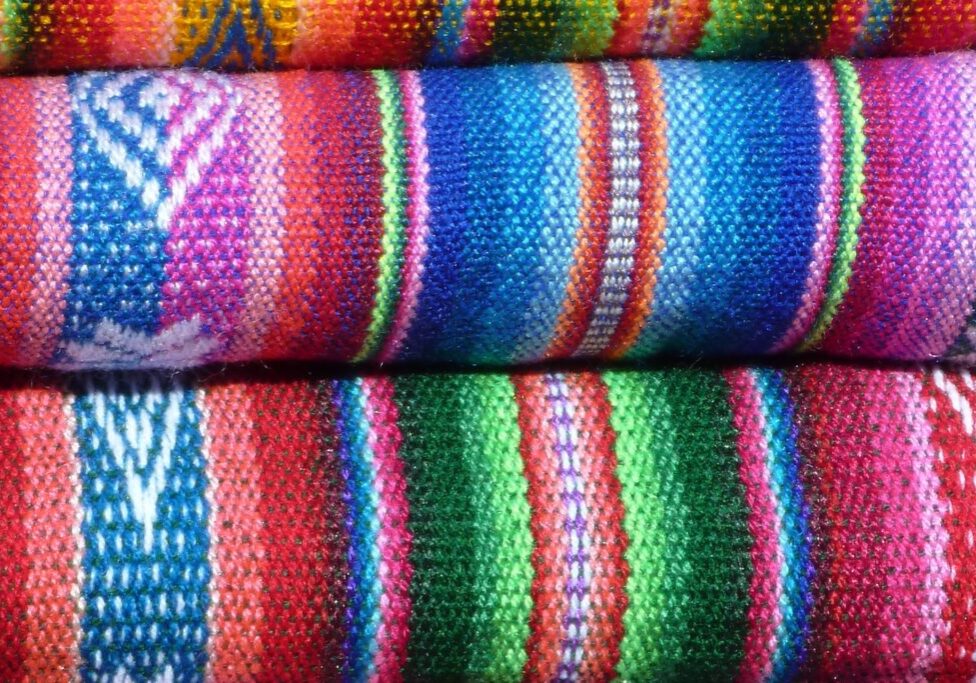 Bales of brightly coloured woven cloth
